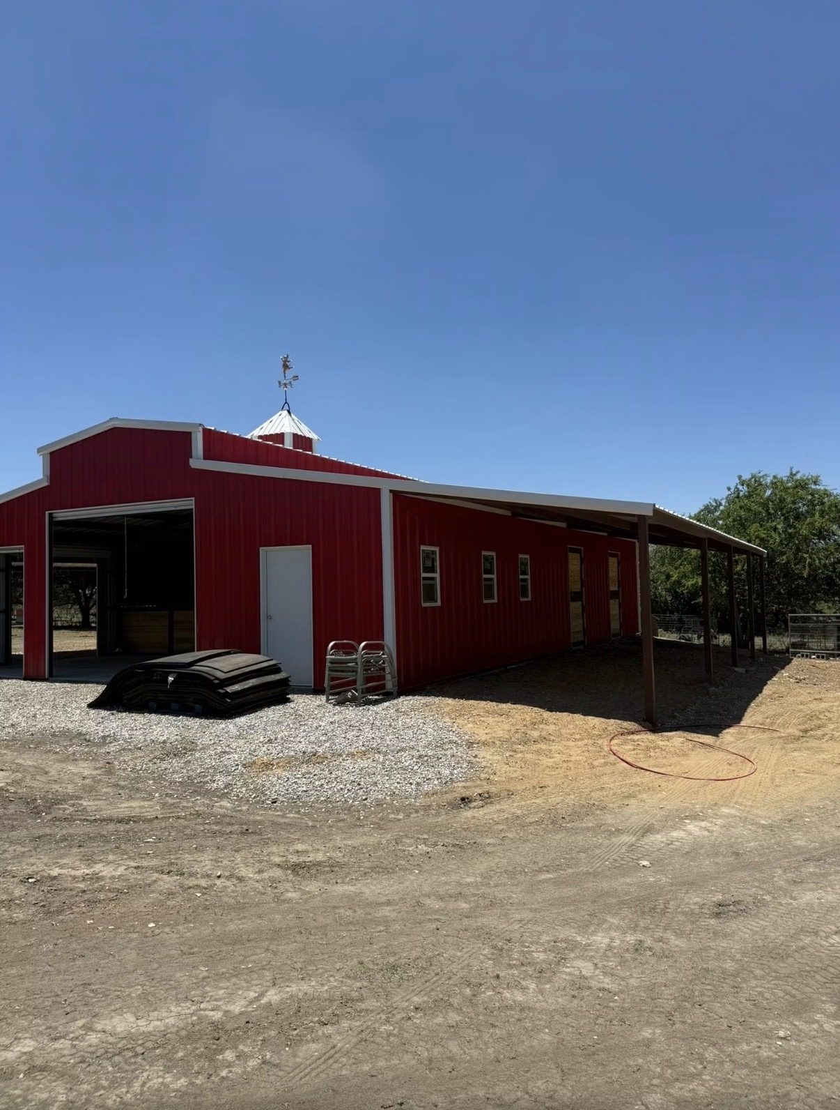 Red horse barn and agricultural metal building by Double B Builders