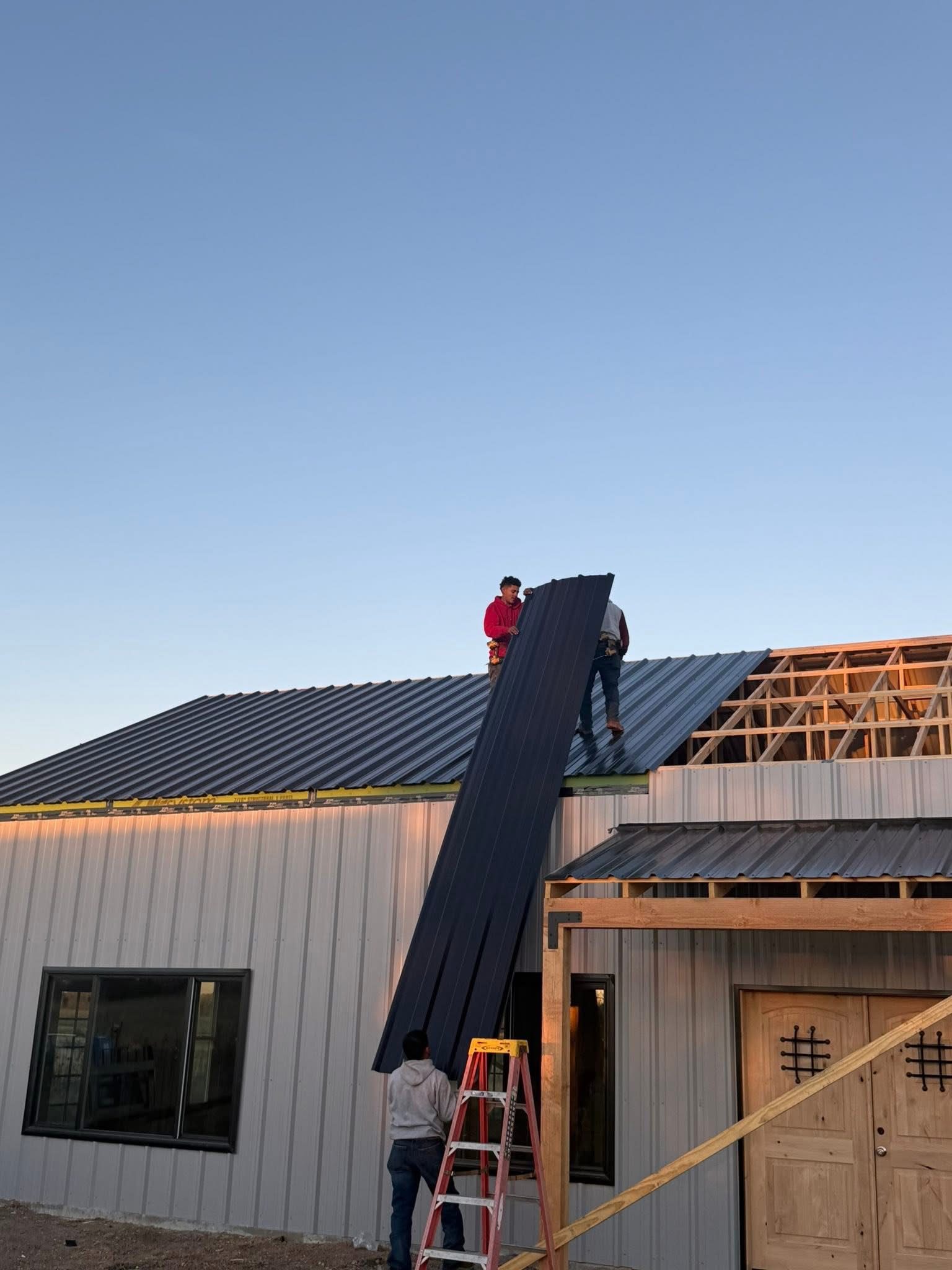 Double B Builders crew installing metal roof panels