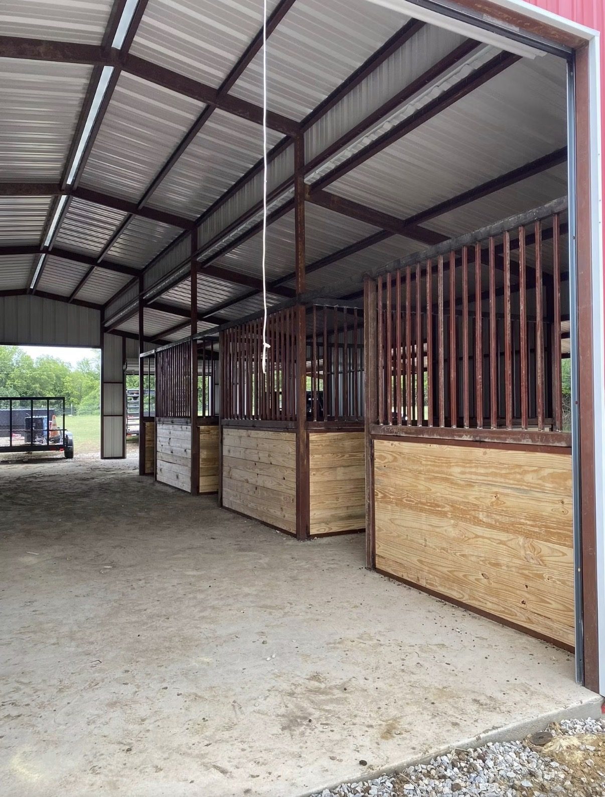 Interior horse stalls in a custom red metal barn